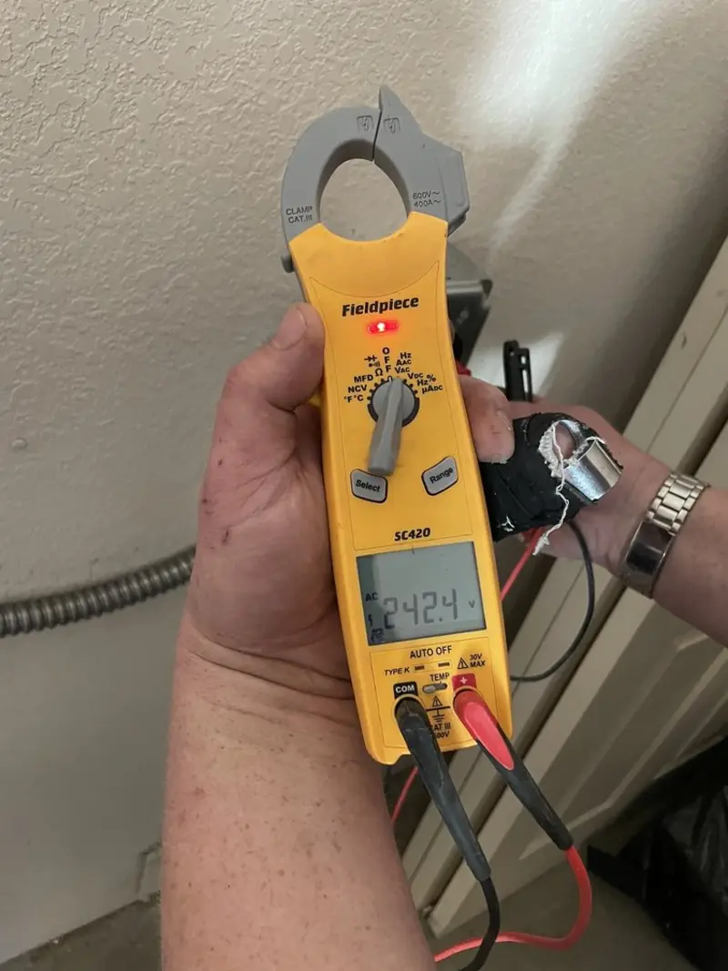 Voltage testing with clamp meter during Recessed Lighting Installation in Greenwich